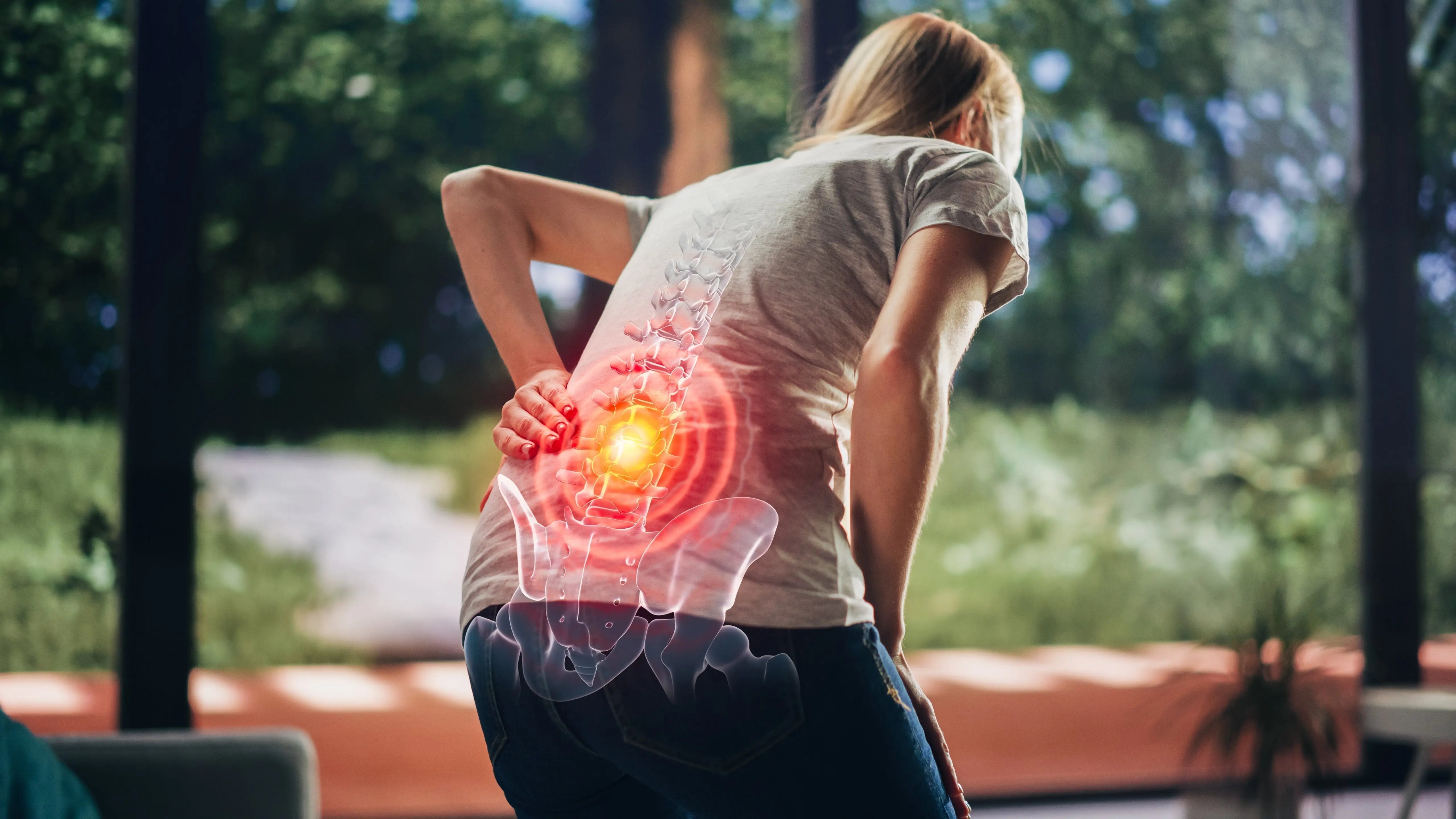 Women touch her back in pain.