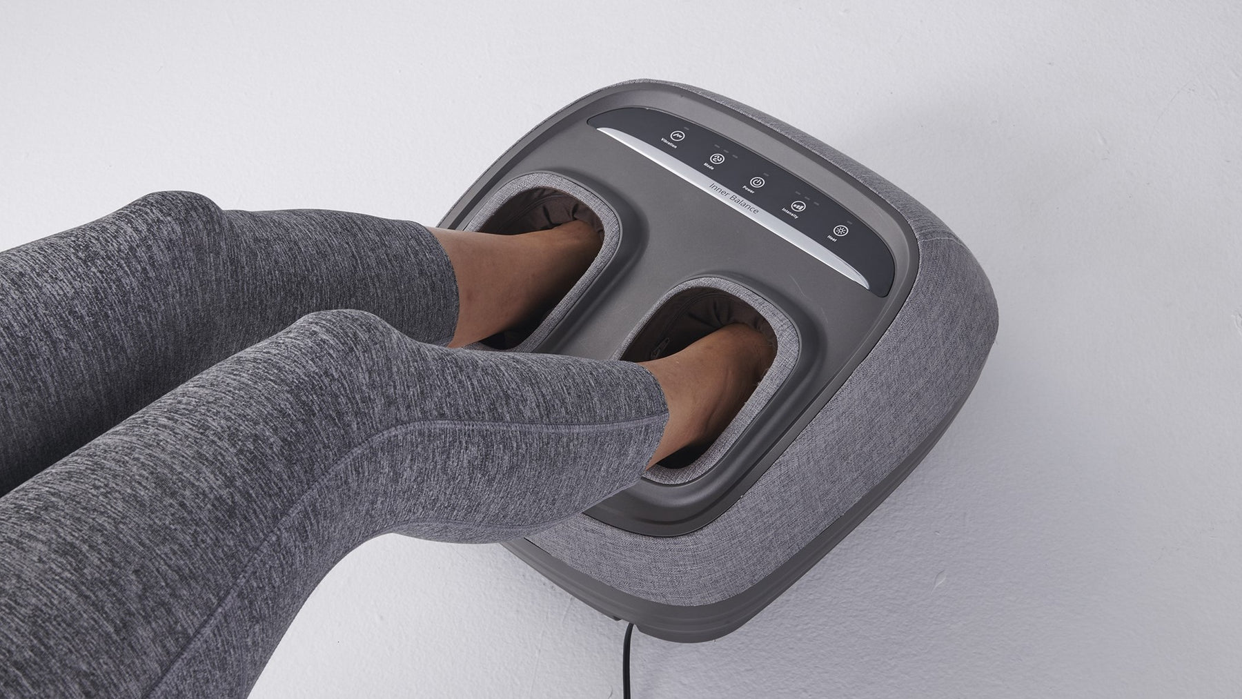 Woman using the Arch Refresh Foot Massager