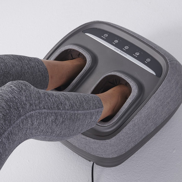 Woman using the Arch Refresh Foot Massager