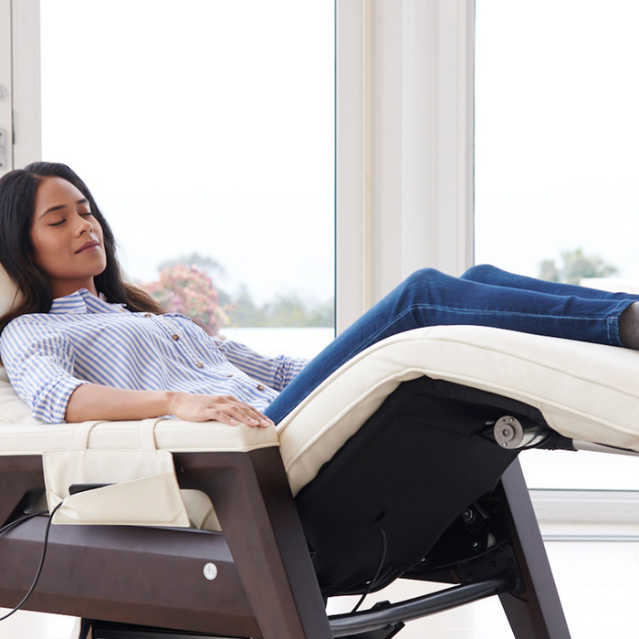 Woman reclining on the Gravis Zero Gravity Recliner by Human Touch