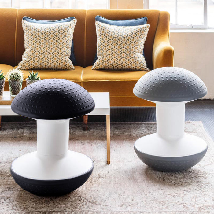 Two Ballo Active Stools in front of a mustard couch.