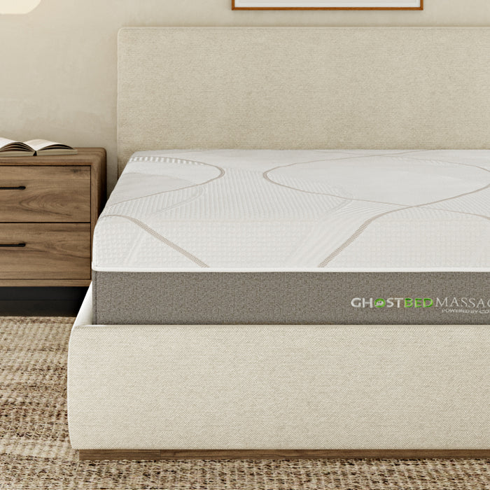 A close up of the A front view of the GhostBed Massage 12" Hybrid Mattress while in a bedroom setting.