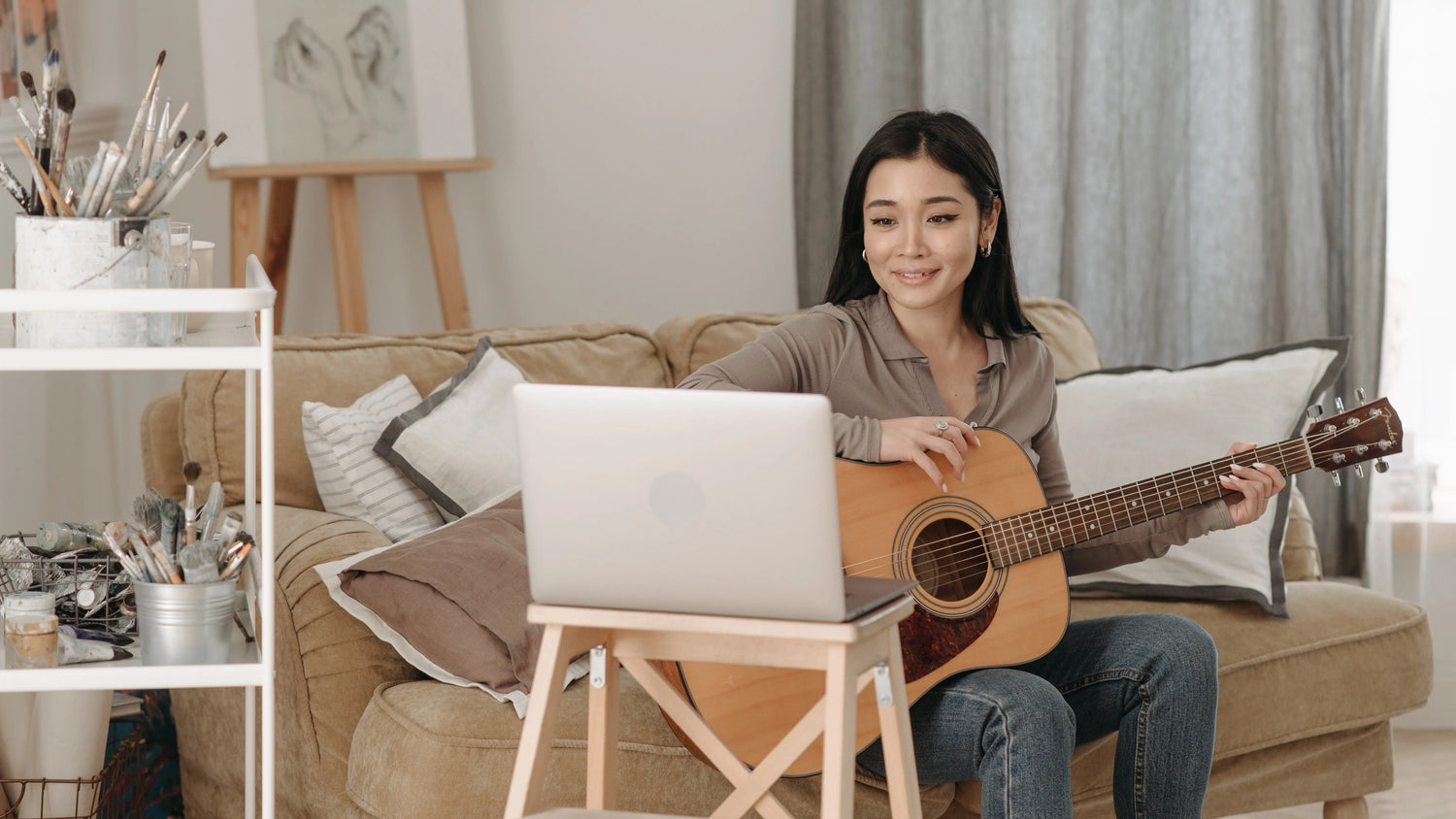 Woman learning to play an acoustic guitar