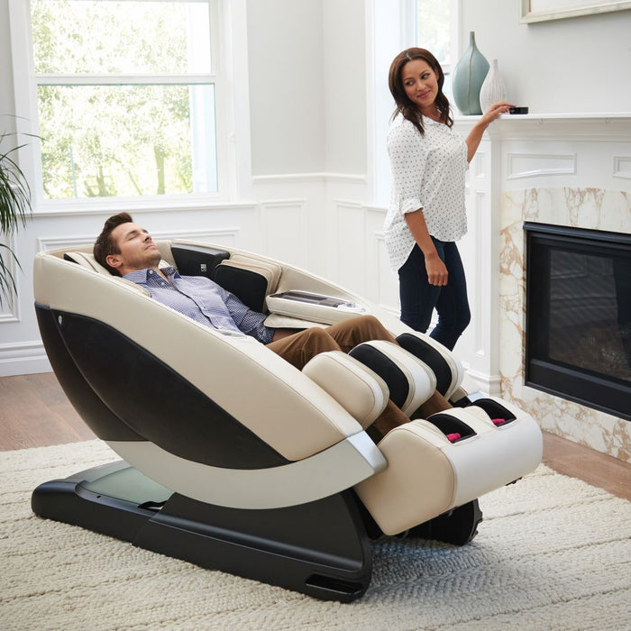Man using a Human Touch Massage Chair and woman standing by him