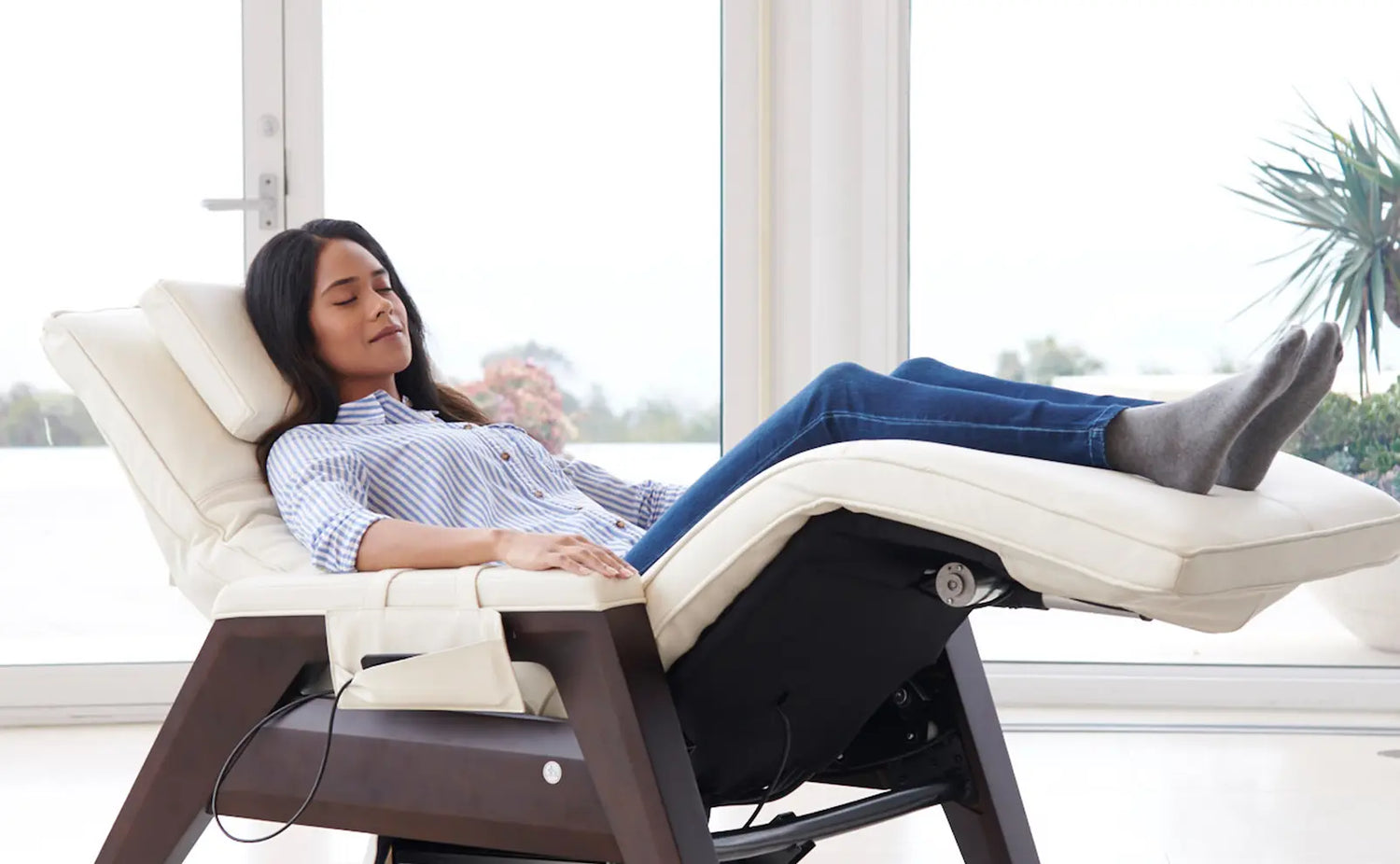 Woman reclining on the Gravis Zero Gravity Recliner by Human Touch