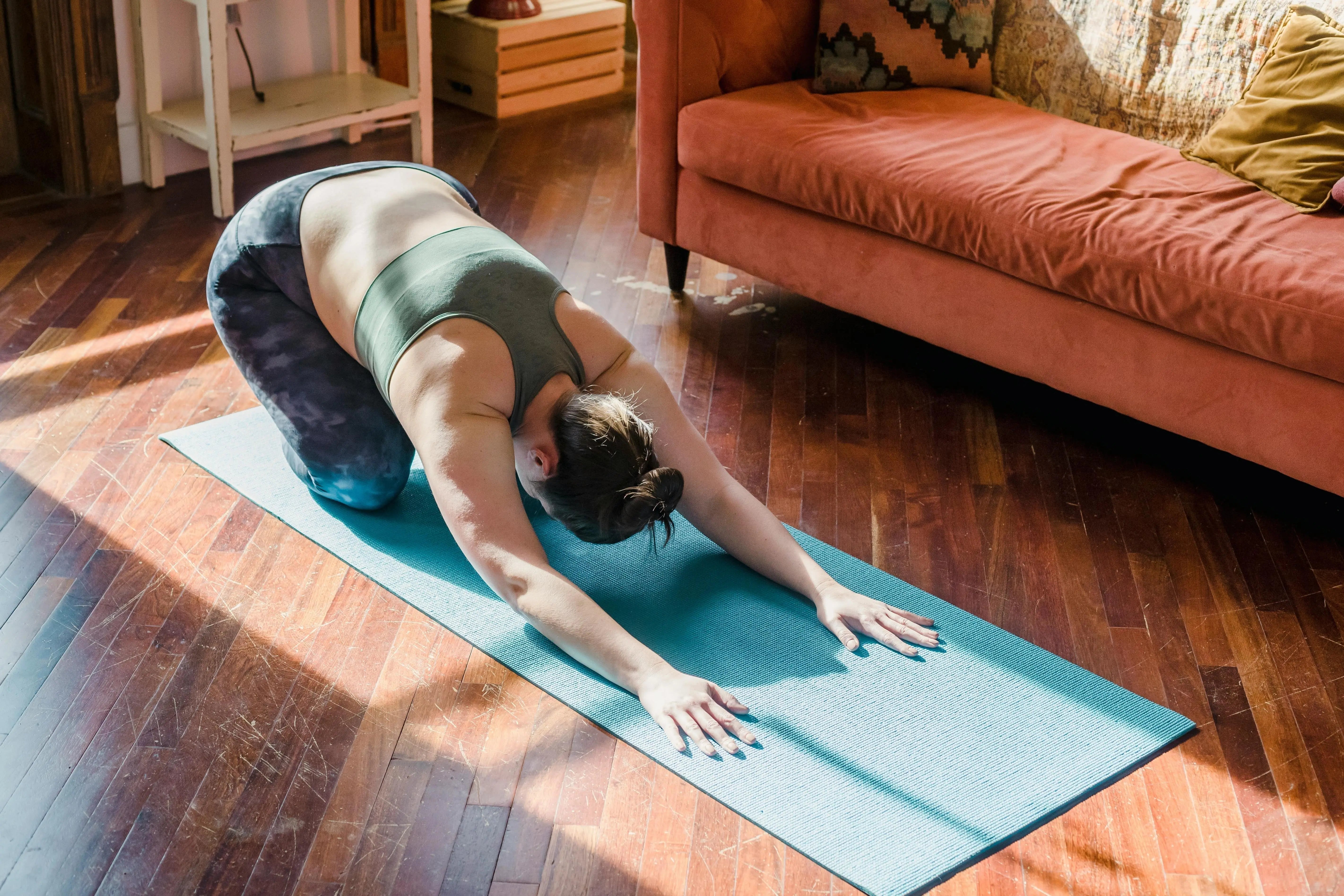 Woman doing the yoga child's pose (balasana)