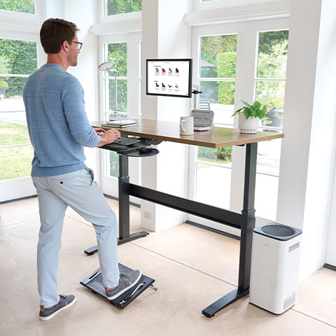 Man using a sit to stand desk