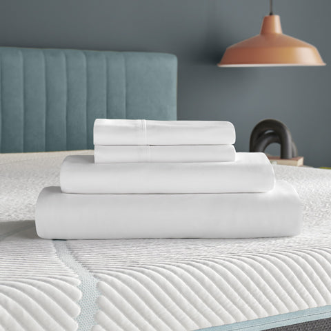 A set of white bed sheets on top of a mattress.