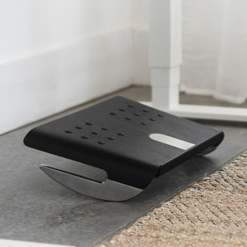 A Humanscale Rocking Foot Rest in black.