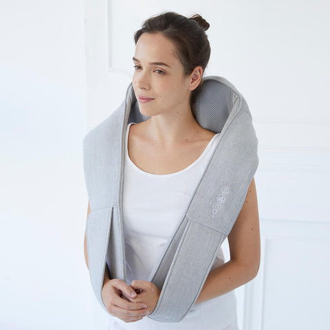 Women using the Theracane to massage her back shoulders