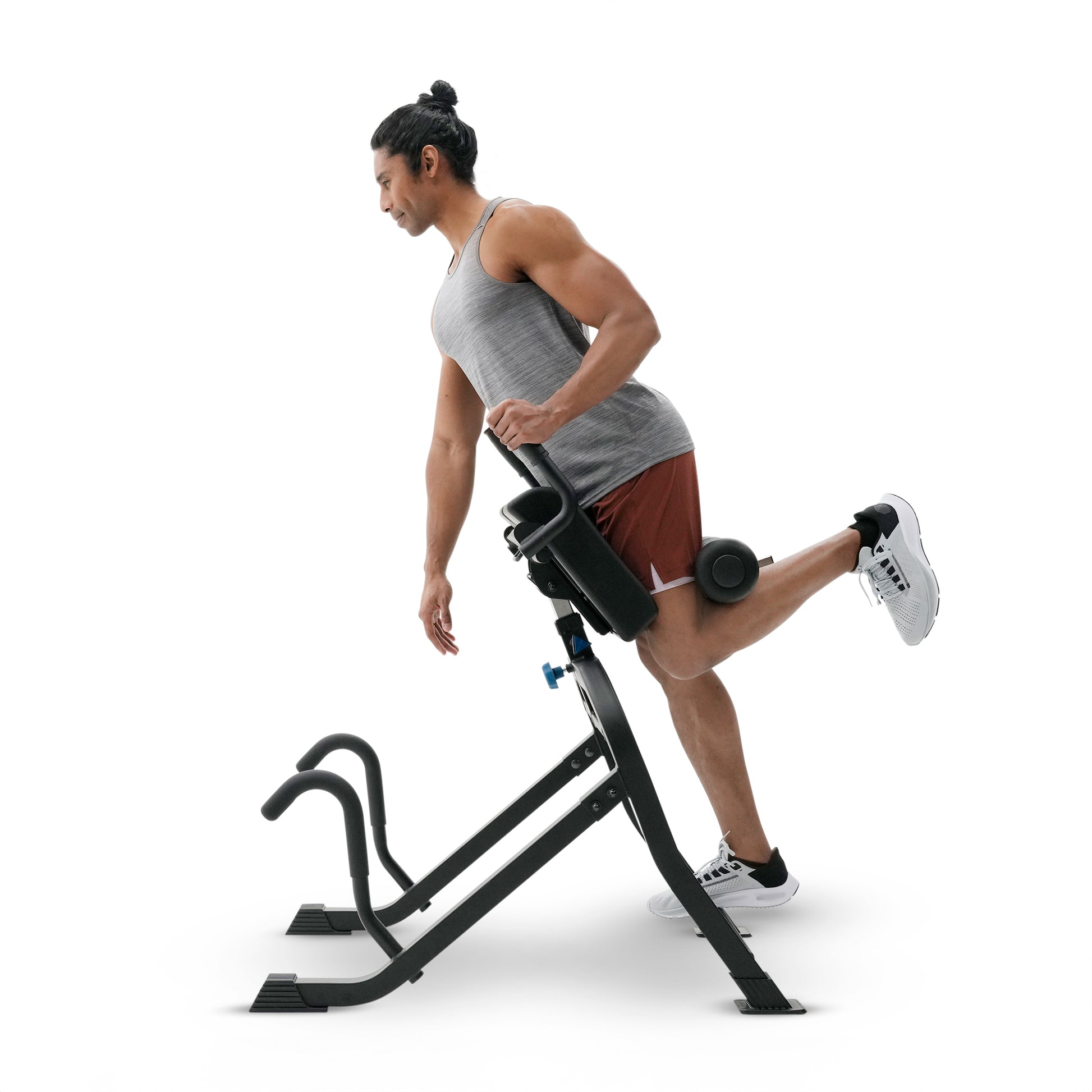 A man using a leg exercise machine on a solid white background.