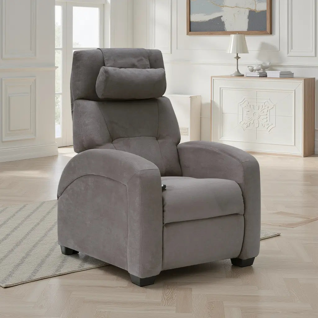 Gray fabric recliner chair with plush cushioning and an adjustable headrest, positioned in a bright living room with wood floors, white paneled walls, and a decorative cabinet in the background.
