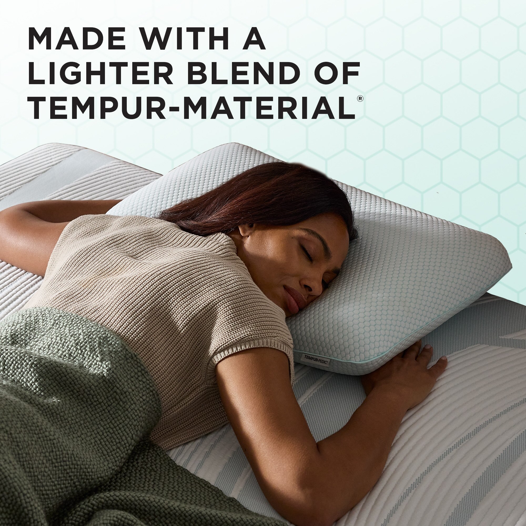Woman sleeping on a Tempur-pedic pillow with text about a lighter blend of Tempur-material.