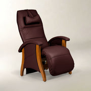 A dark burgundy faux leather recliner chair with a matching headrest pillow and adjustable footrest, featuring light brown wooden legs and arm supports, set against a neutral light gray background.