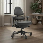 Gray office chair in a room with a desk and plants