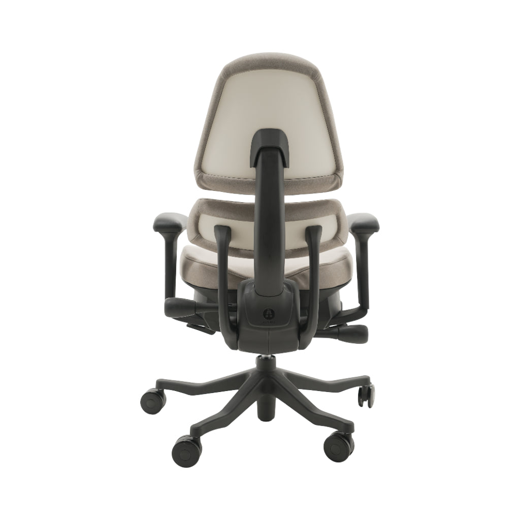 An ergonomic office chair with a high back, adjustable armrests, and a four-wheel base, shown from a rear angle on a white background.