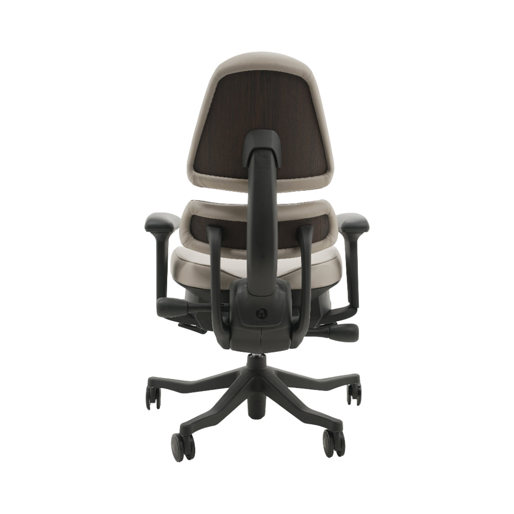 An ergonomic office chair with a high back, adjustable armrests, and a four-wheel base, shown from a rear angle on a white background.