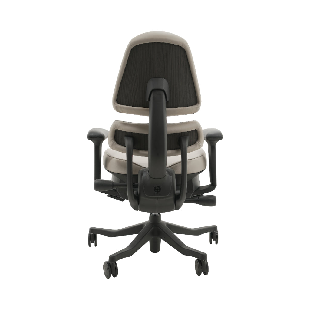 An ergonomic office chair with a high back, adjustable armrests, and a four-wheel base, shown from a rear angle on a white background.