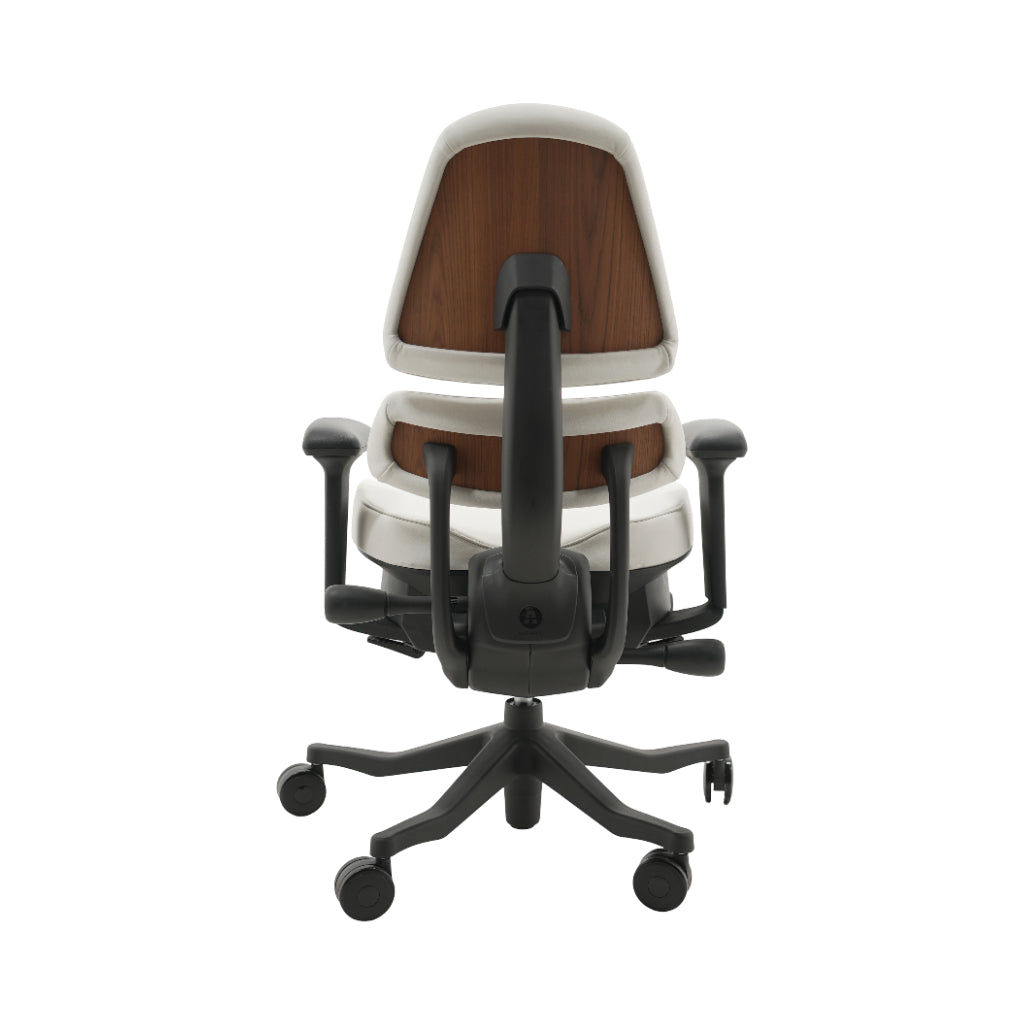 An ergonomic office chair with a high back, adjustable armrests, and a four-wheel base, shown from a rear angle on a white background.
