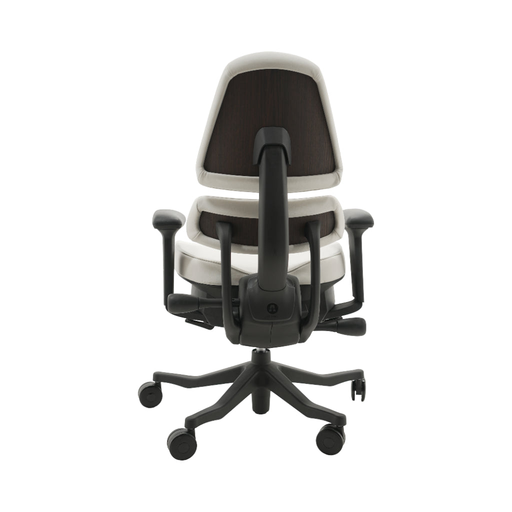 An ergonomic office chair with a high back, adjustable armrests, and a four-wheel base, shown from a rear angle on a white background.