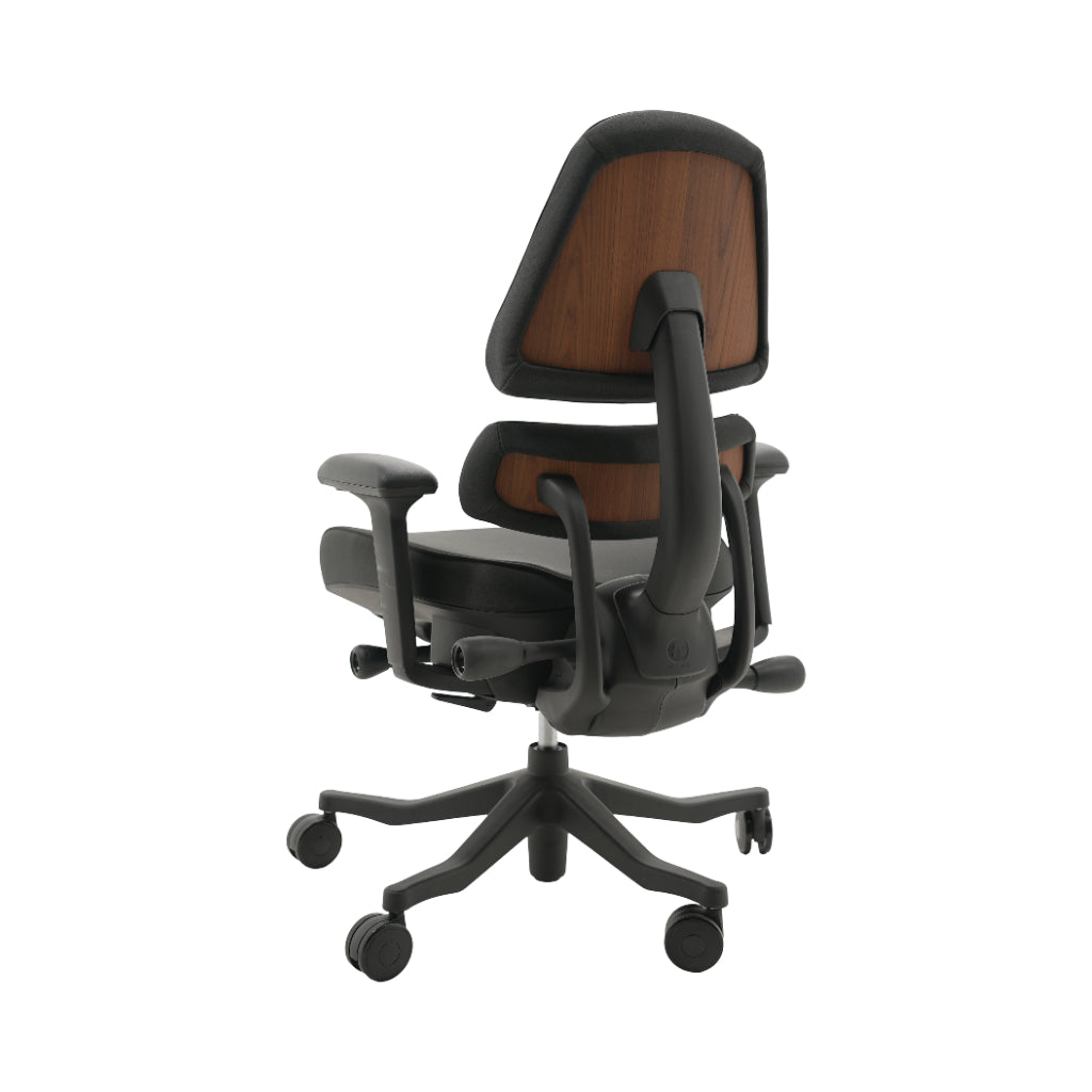 An ergonomic office chair with a high back, adjustable armrests, and a four-wheel base, shown from a rear angle on a white background.