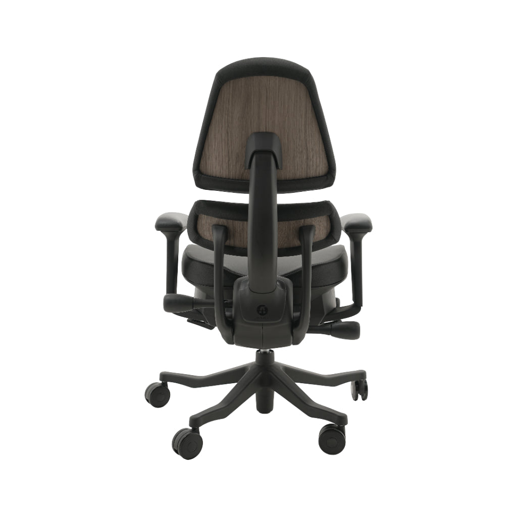 An ergonomic office chair with a high back, adjustable armrests, and a four-wheel base, shown from a rear angle on a white background.