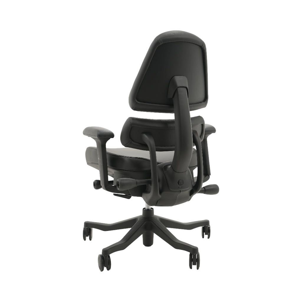 An ergonomic office chair with a high back, adjustable armrests, and a four-wheel base, shown from a rear angle on a white background.