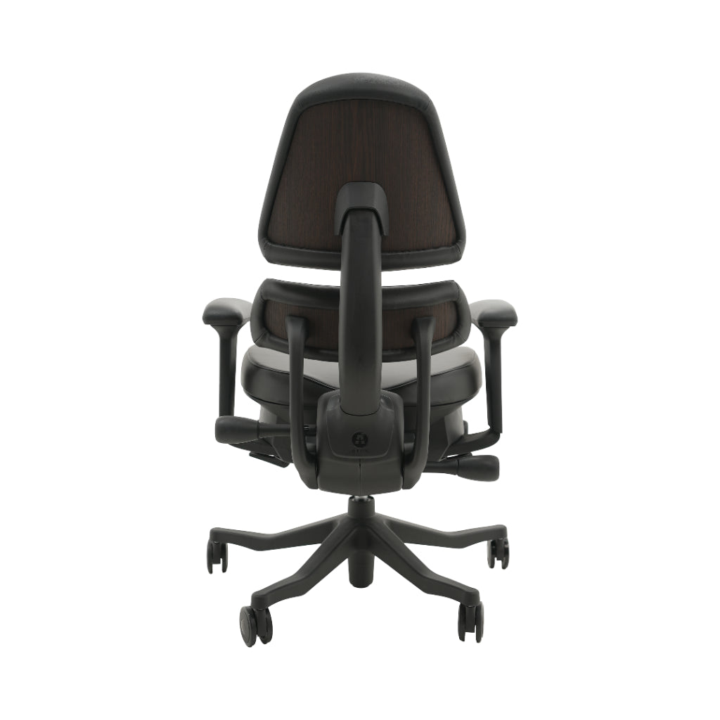 An ergonomic office chair with a high back, adjustable armrests, and a four-wheel base, shown from a rear angle on a white background.