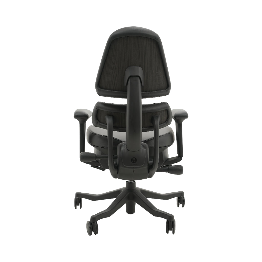 An ergonomic office chair with a high back, adjustable armrests, and a four-wheel base, shown from a rear angle on a white background.