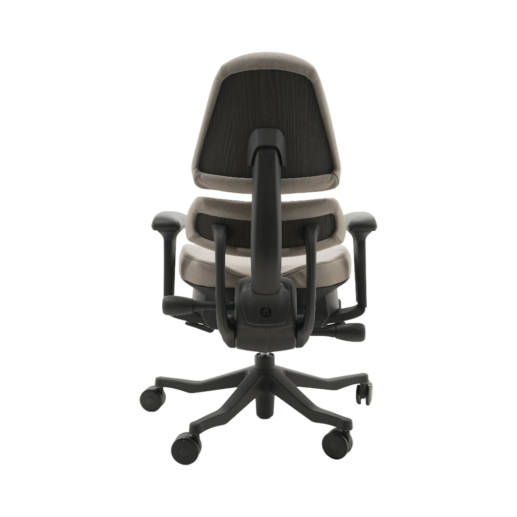 An ergonomic office chair with a high back, adjustable armrests, and a four-wheel base, shown from a rear angle on a white background.