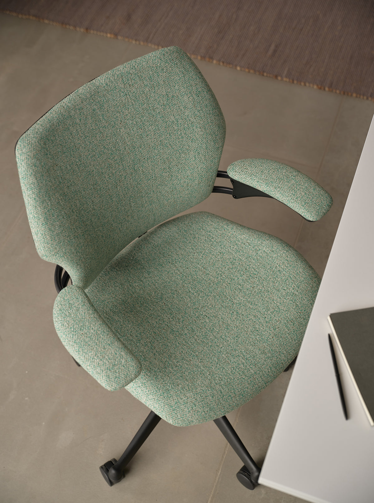 Green office chair on a neutral background