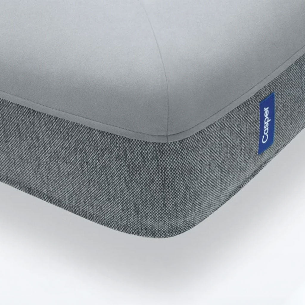 Gray mattress cover with a visible Casper logo on a white background