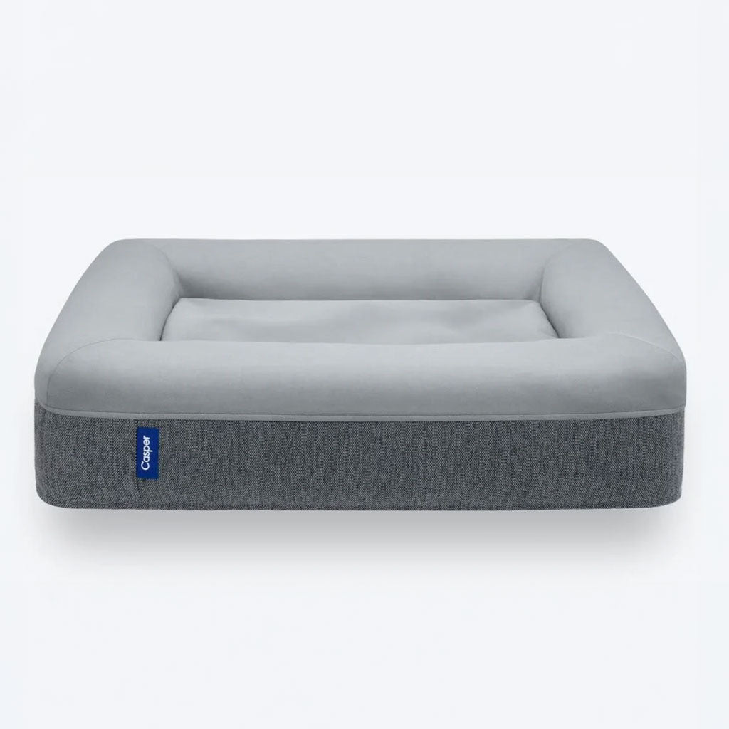 Gray pet bed with a blue tag on a white background