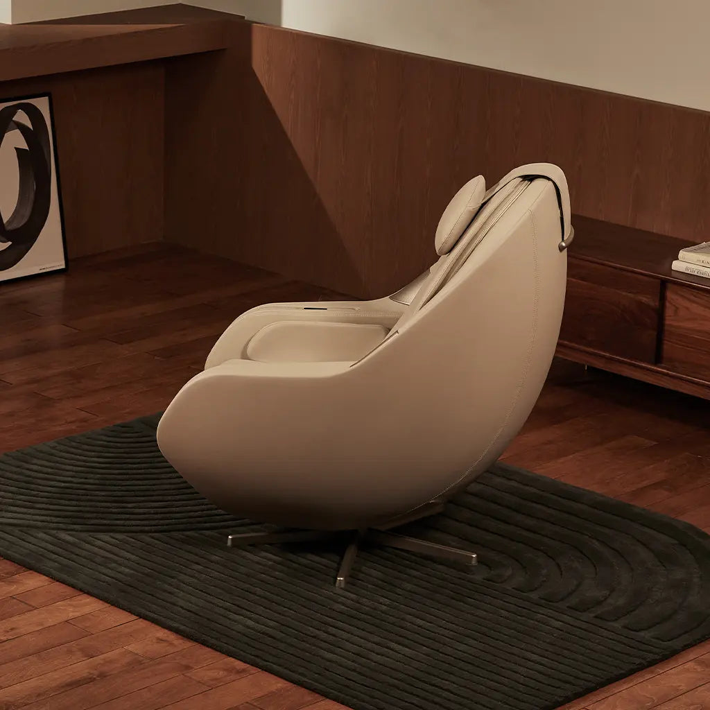 Beige massage chair in a room with wooden flooring and furniture.