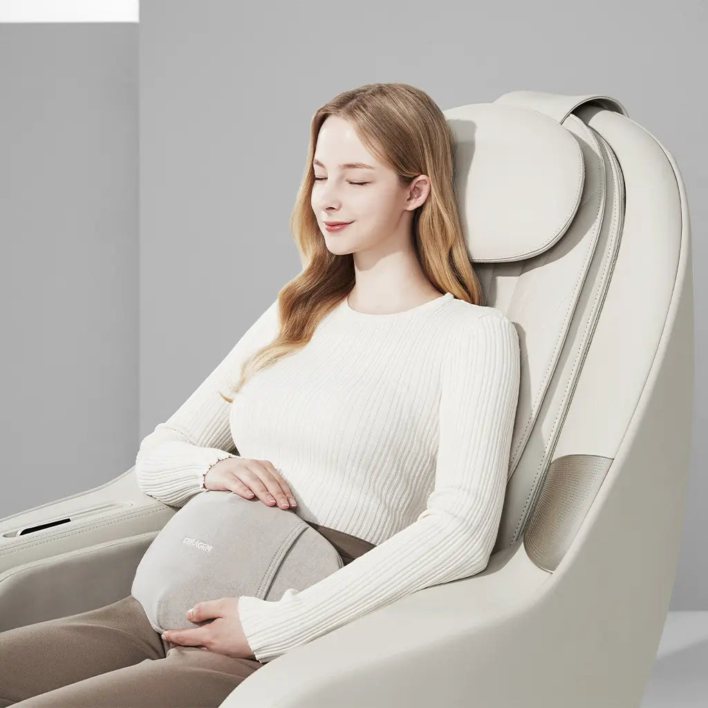Woman using a massage chair in a modern setting using the chair's massage cushion on her stomach.