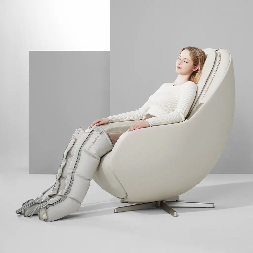 Woman using a white massage chair with leg massager on a gray background