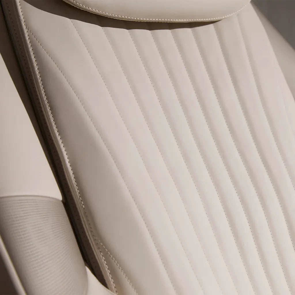 Close-up of the leather on the M6 Massage Chair with stitching details.