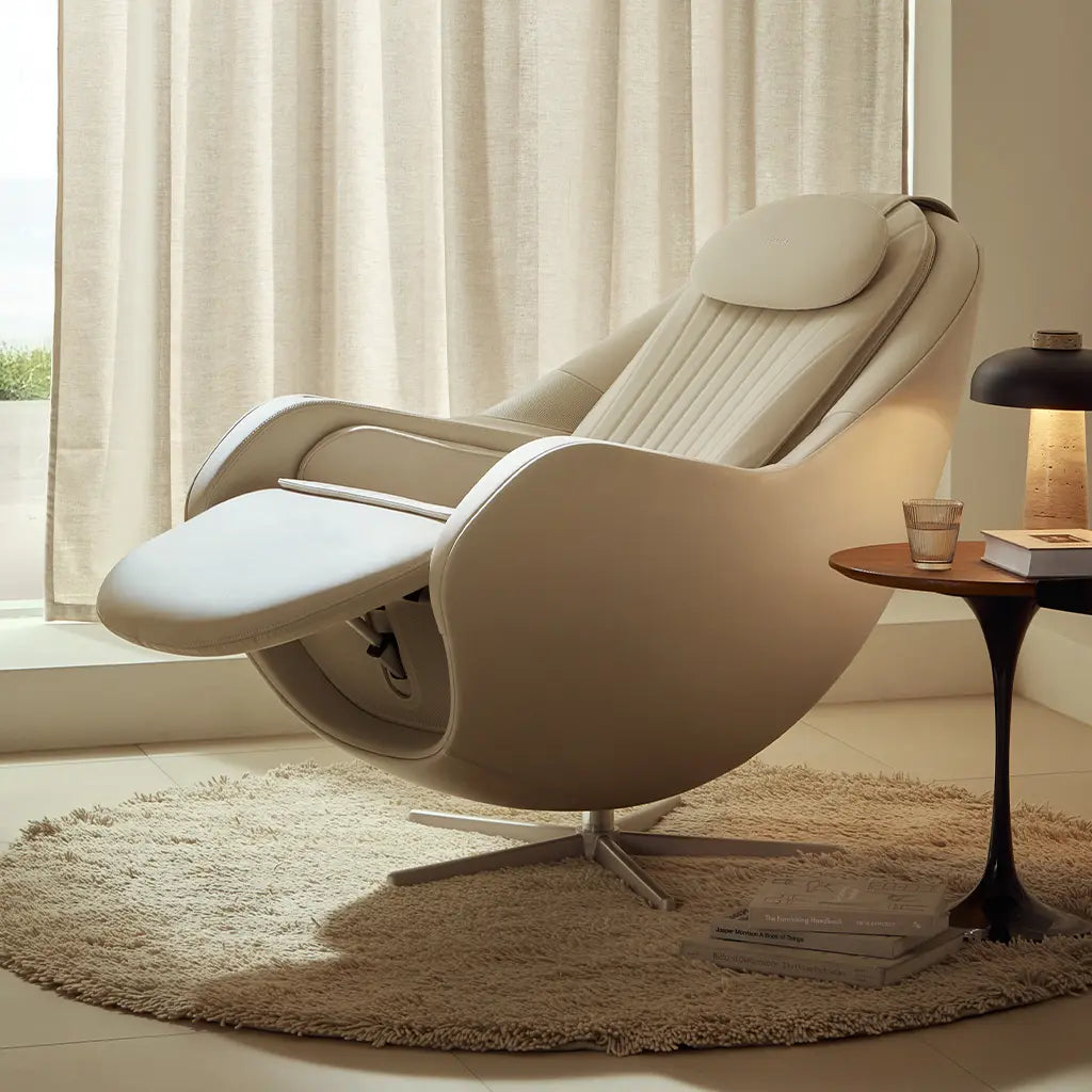 Beige recliner chair in a modern living room with a side table and lamp.