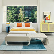 Modern bedroom with a bed, nightstand, and yellow cabinet.