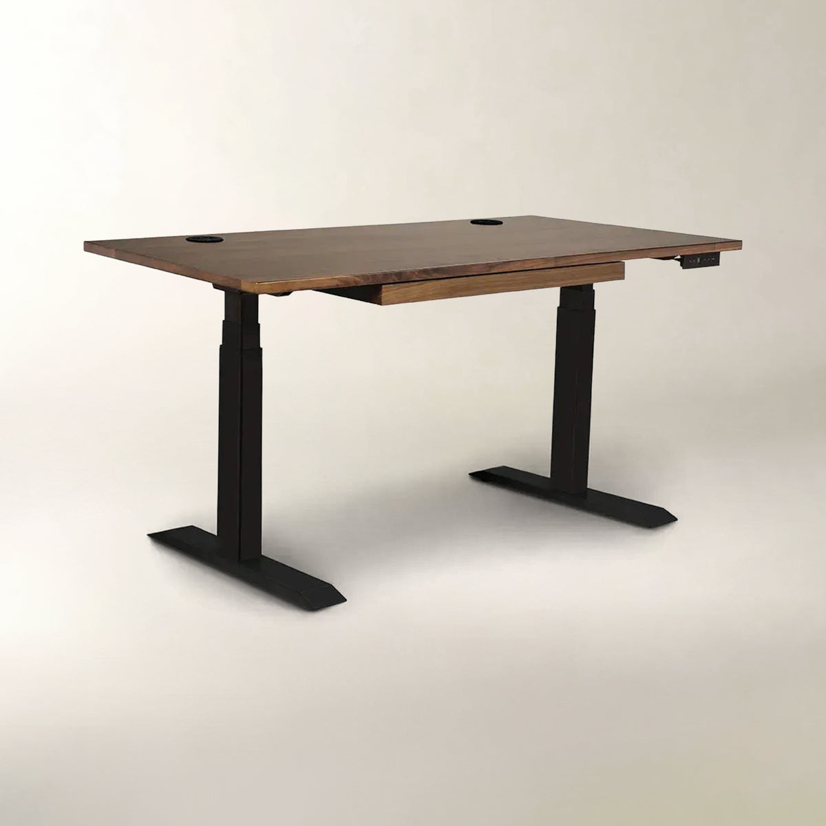 A modern adjustable standing desk with a dark brown wood-grain top and black metal legs, shown on a neutral light gray background.