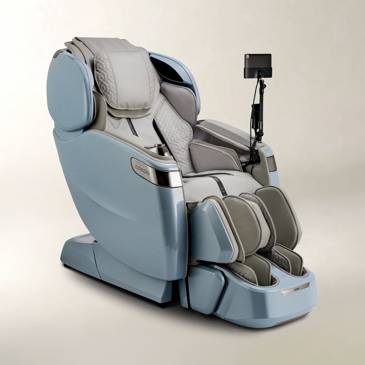 A modern massage chair in light blue and gray, shown from a three-quarters angle on a neutral beige studio background.