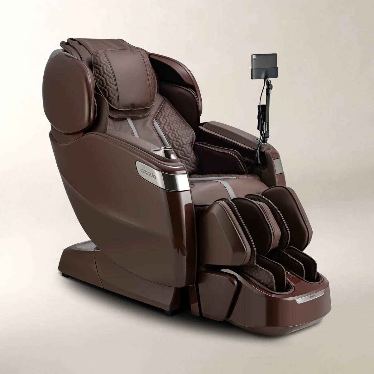A premium brown massage chair with a matching foot massager attachment, featuring quilted backrest padding, silver trim accents, and an adjustable arm-mounted screen, shown on a neutral beige background.