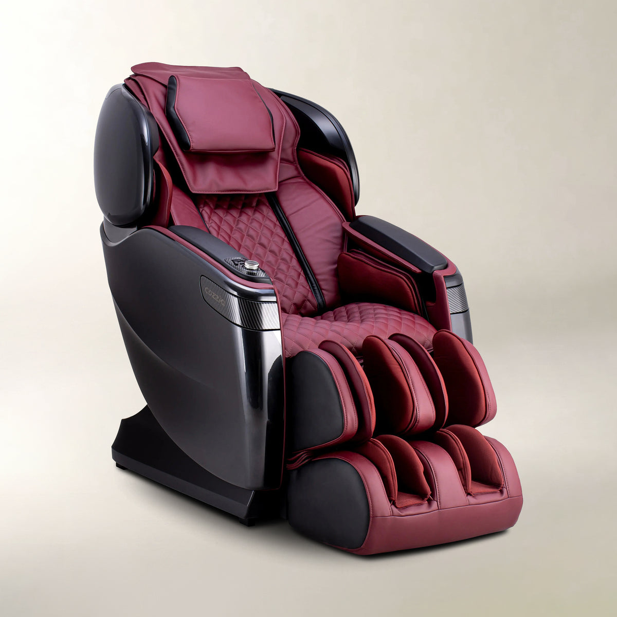 A modern massage chair upholstered in deep burgundy and black faux leather, shown on a neutral beige studio background.