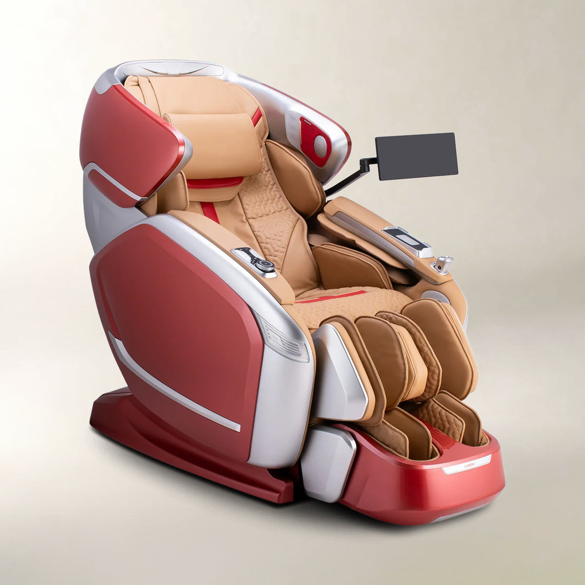 A modern full-body massage chair in red, beige, and silver, shown from a three-quarters angle on a light beige background. It features a headrest, lumbar support, adjustable armrests, and a small black screen mounted on the side.