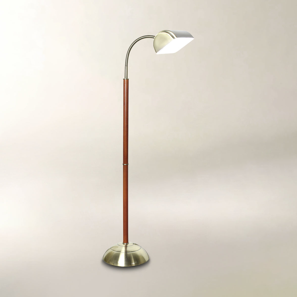 Cherrywood and antique brass floor lamp with a curved adjustable neck and dome-shaped shade.

