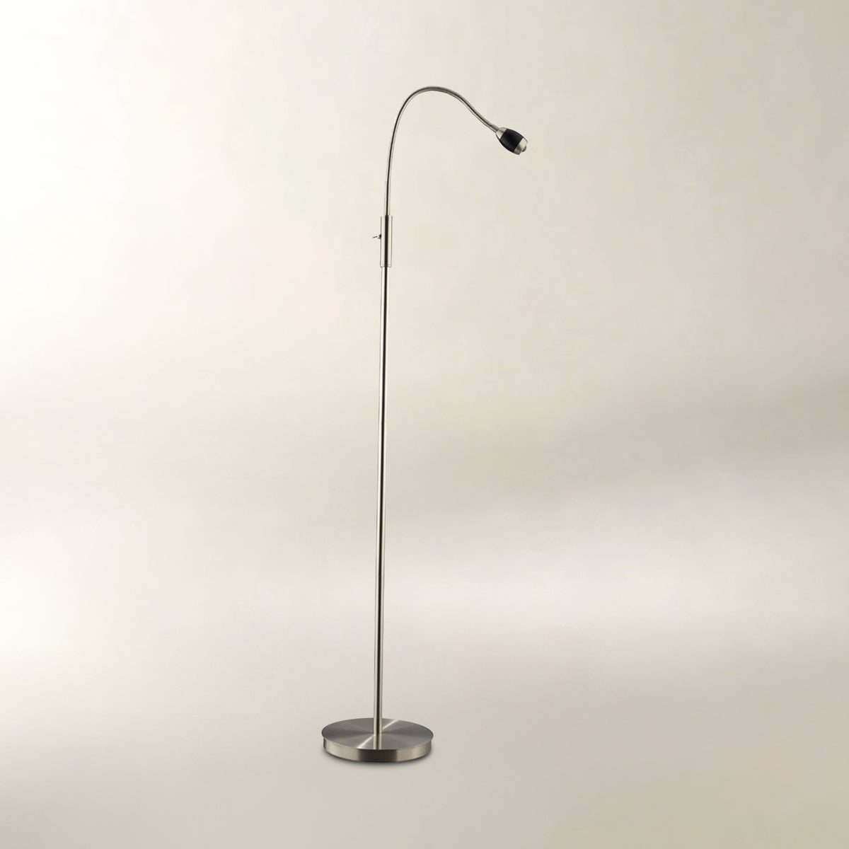 A modern floor lamp with a slim curved neck, a circular base, and a small black globe shade, shown against a plain light gray background.