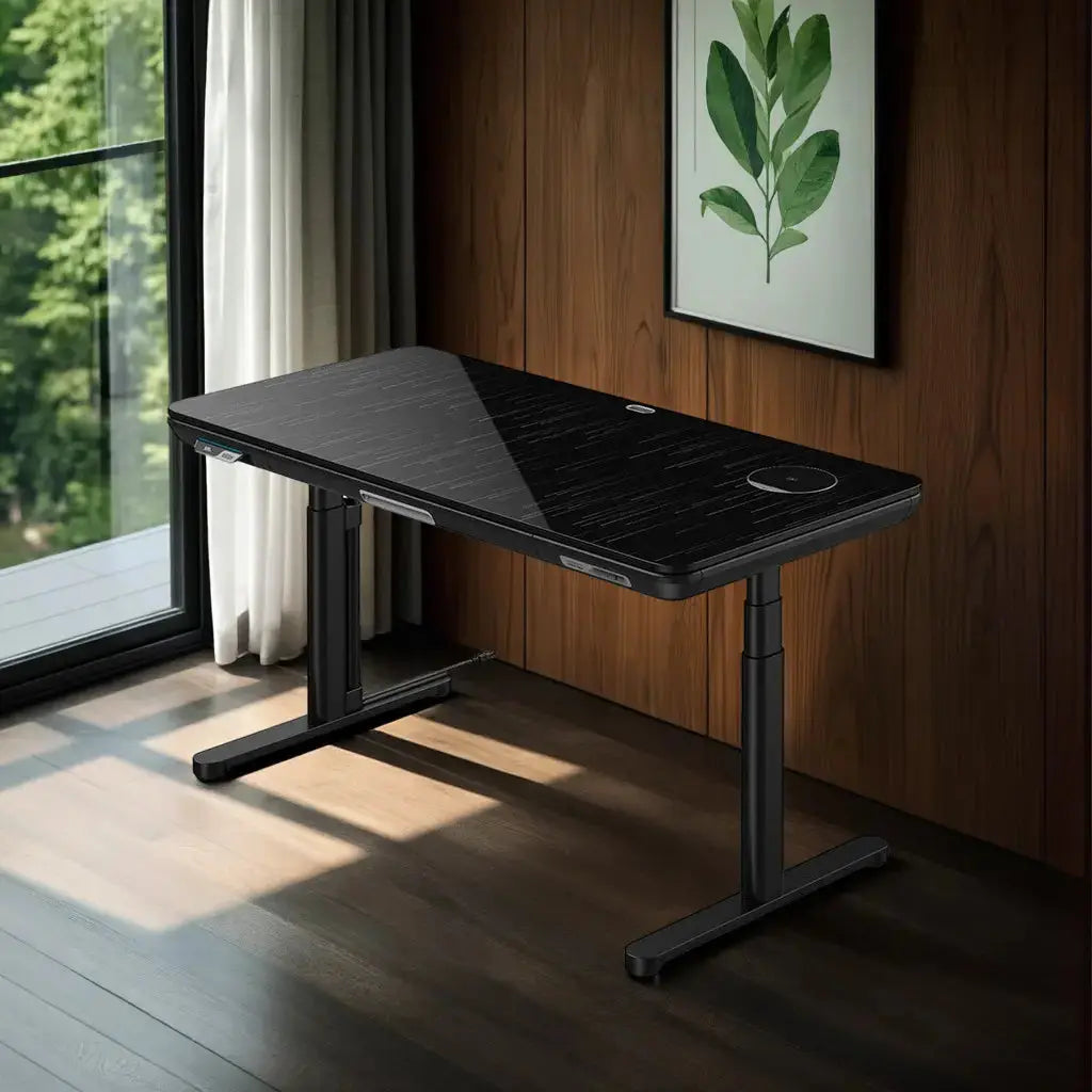A modern black standing desk with a sleek glass surface sits in a sunlit room with wood paneling and a large window.