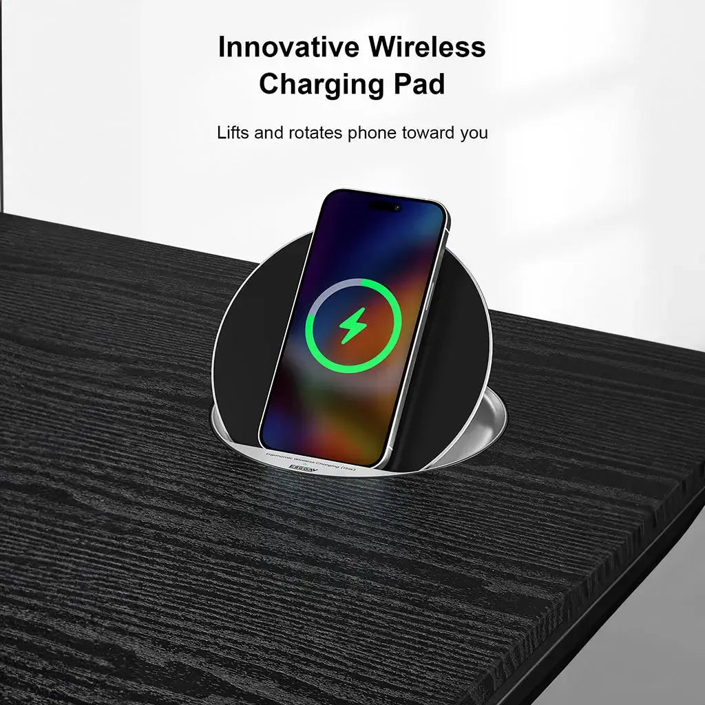 A phone sits on a round wireless charging pad embedded in a black desk, with charging in progress.