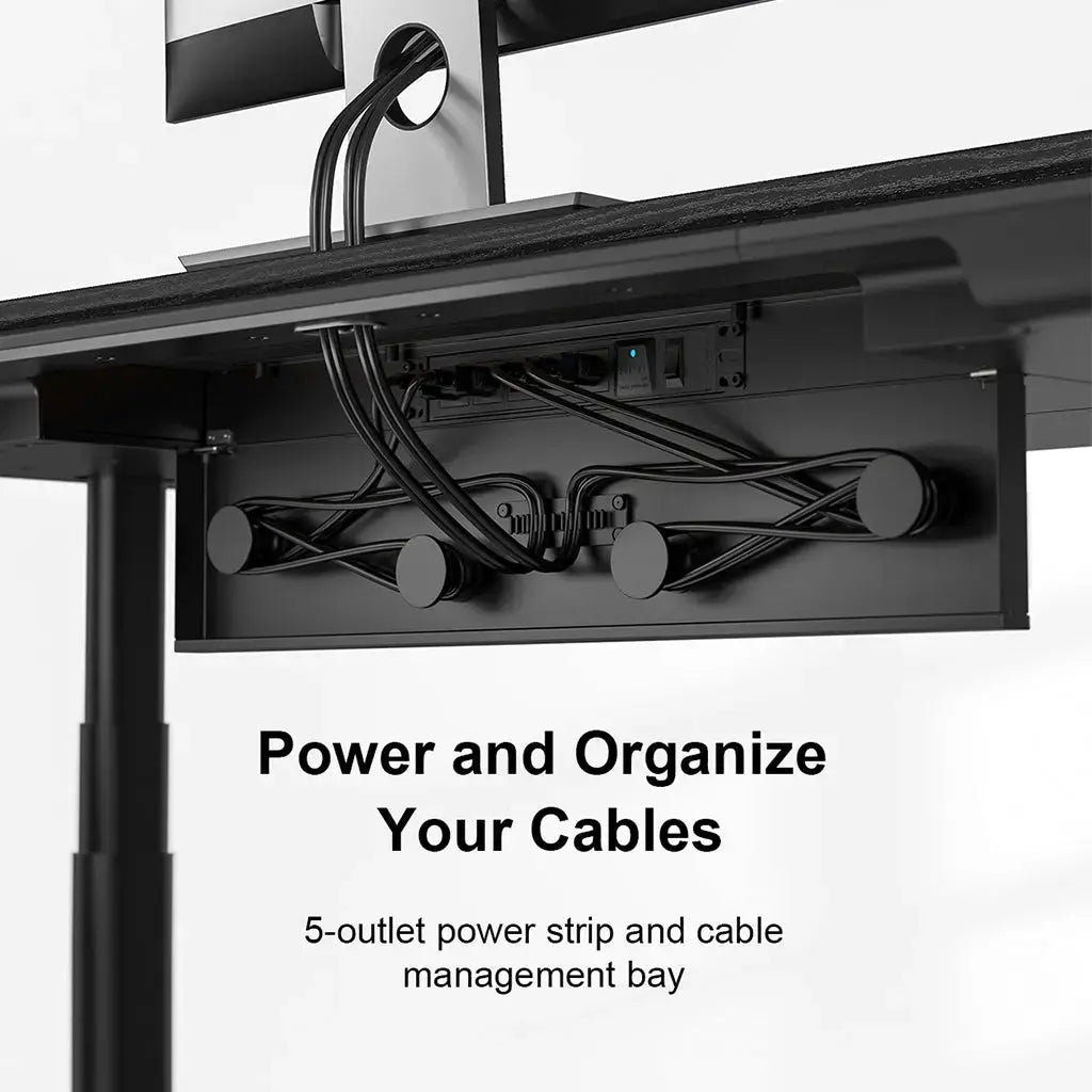 Under-desk view of a cable management bay with organized cords and a built-in power strip.