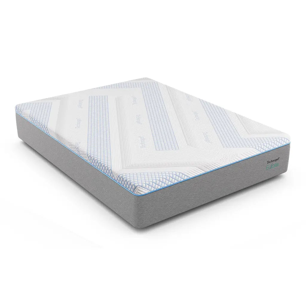 A Technogel® Euforia mattress is shown on a white background, featuring a smooth gray base and a breathable white top cover with blue geometric accents. The design highlights its clean lines and modern aesthetic.